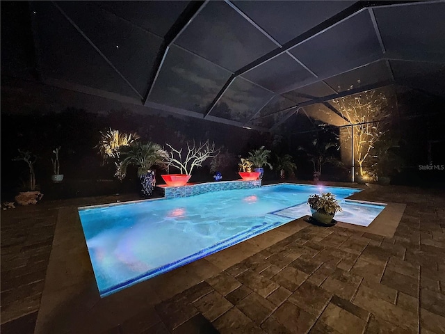 view of pool featuring a lanai and a patio