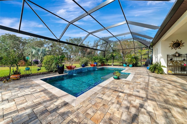 view of swimming pool with pool water feature, a patio area, and a lanai