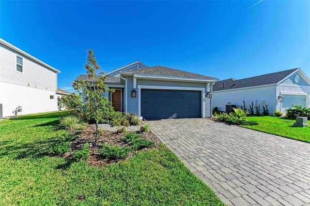 single story home with a garage and a front lawn