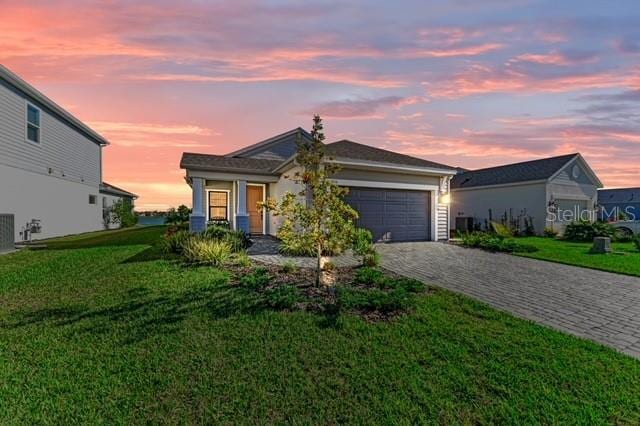 view of front of house featuring a yard and a garage