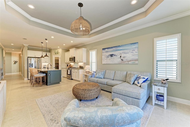 living room featuring crown molding, light tile patterned floors, and a tray ceiling