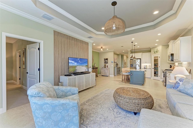 tiled living room with crown molding and a raised ceiling