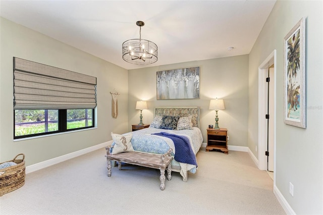 bedroom featuring an inviting chandelier and carpet