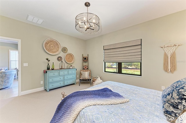 bedroom with carpet and a chandelier