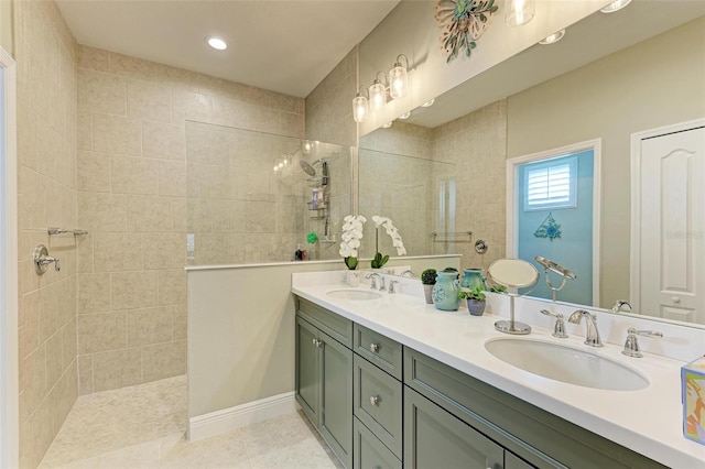 bathroom with vanity, tile patterned flooring, and tiled shower