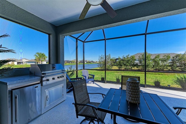 view of patio / terrace featuring grilling area, area for grilling, a water view, a lanai, and ceiling fan