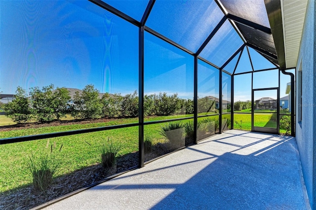 unfurnished sunroom featuring lofted ceiling