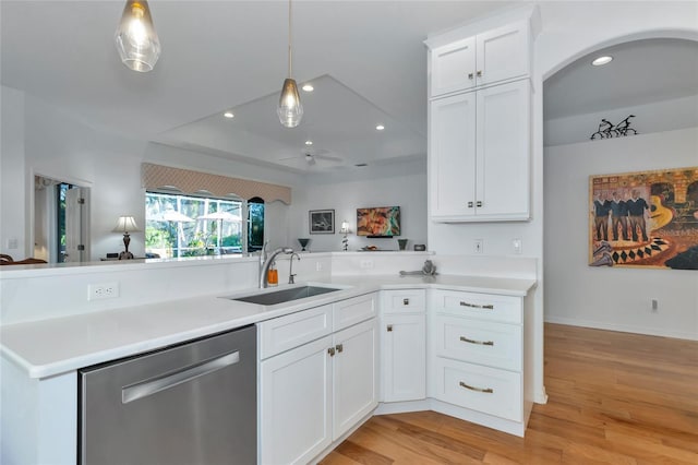 kitchen with kitchen peninsula, sink, white cabinets, and stainless steel dishwasher