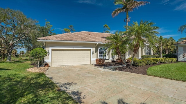 mediterranean / spanish-style house featuring a garage and a front yard