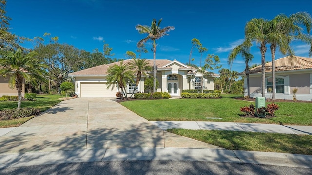 view of front of home with a garage and a front lawn