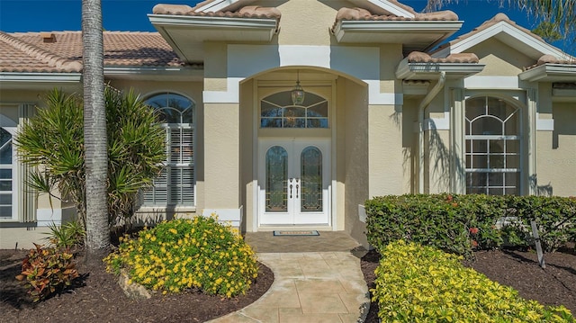 view of exterior entry featuring french doors