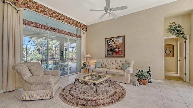 living room with ceiling fan, ornamental molding, and light tile patterned floors