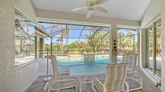 sunroom with a swimming pool and ceiling fan