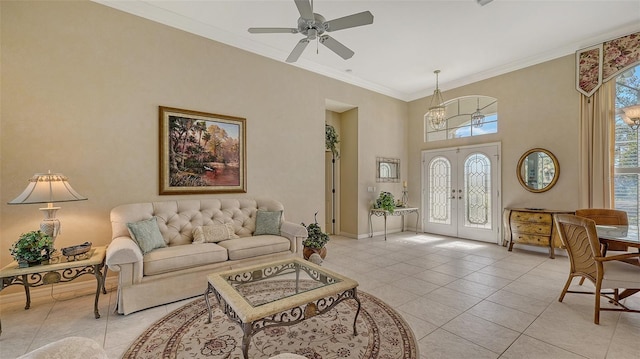 living room with light tile patterned floors, ceiling fan, a high ceiling, ornamental molding, and french doors