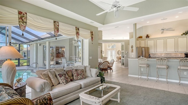 tiled living room featuring high vaulted ceiling, a healthy amount of sunlight, and ceiling fan