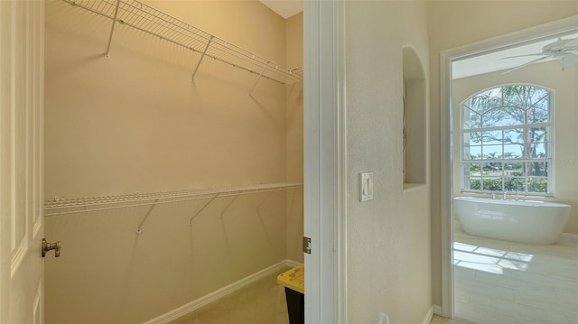 spacious closet with ceiling fan