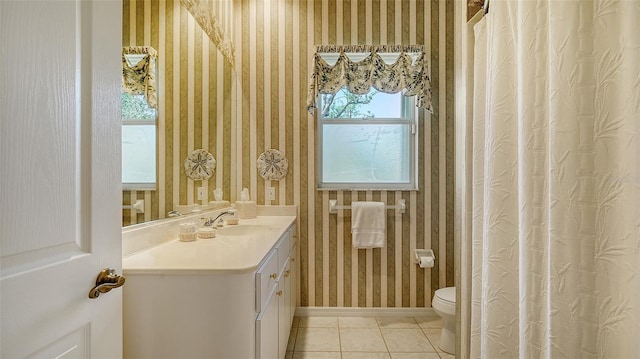 bathroom featuring vanity, tile patterned floors, and toilet