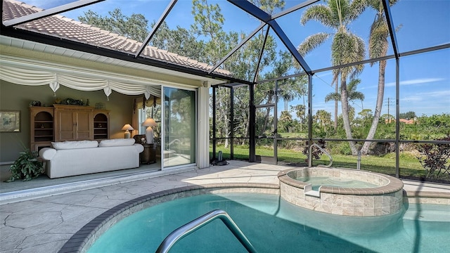 view of pool featuring an in ground hot tub, glass enclosure, and a patio area