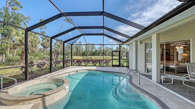 view of pool featuring an in ground hot tub, a patio area, and glass enclosure