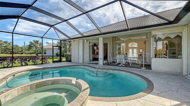 view of swimming pool with ceiling fan, glass enclosure, a patio area, french doors, and an in ground hot tub