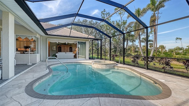 view of pool with an in ground hot tub, a lanai, and a patio area