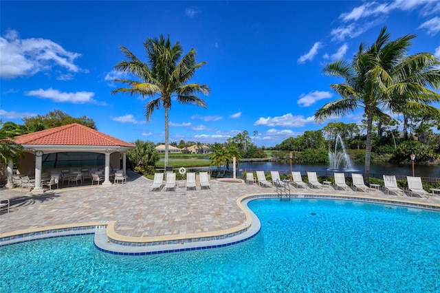 view of pool with a gazebo and a water view