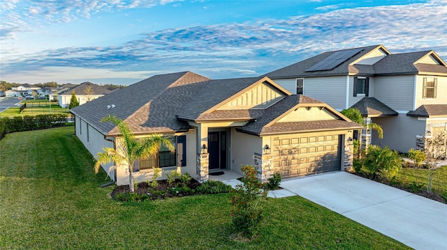 view of front of home with a garage and a front lawn