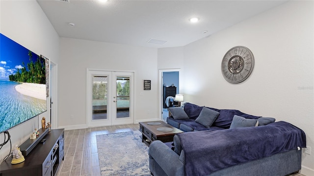 living room with french doors and light wood-type flooring