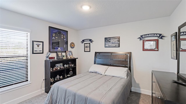 bedroom featuring carpet flooring and a textured ceiling