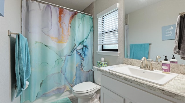 bathroom featuring vanity, curtained shower, and toilet