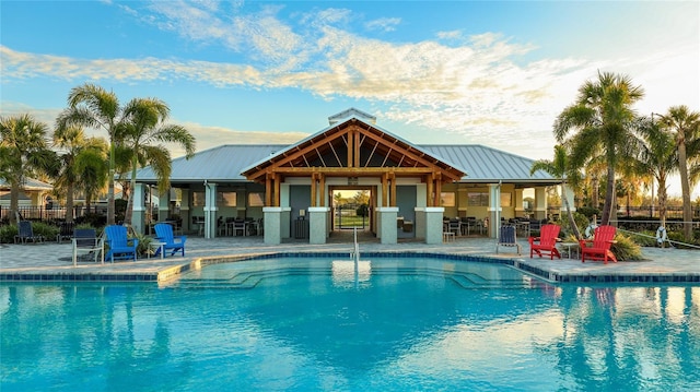 view of swimming pool featuring a patio area and an outbuilding