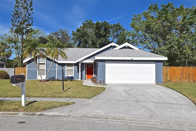 ranch-style home with a garage and a front lawn