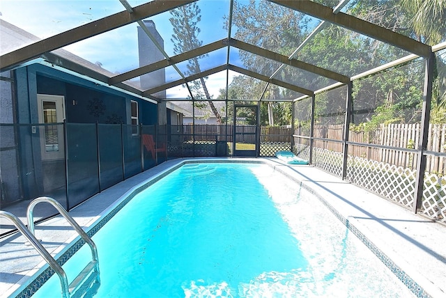 view of pool with glass enclosure