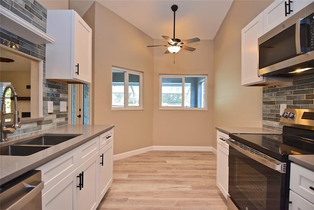 kitchen featuring white cabinets, sink, stainless steel appliances, and tasteful backsplash