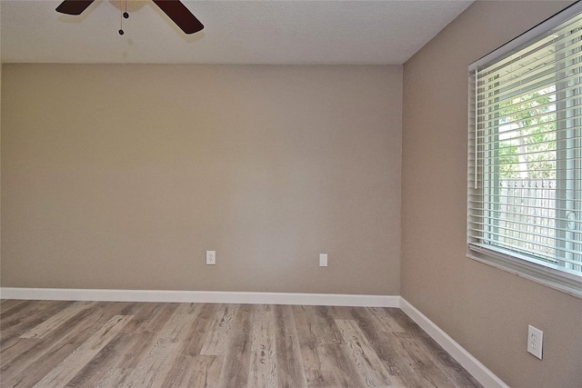 empty room featuring ceiling fan and light wood-type flooring