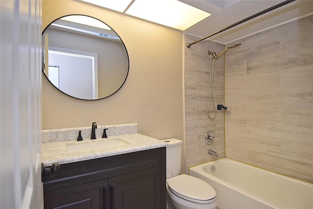 full bathroom with vanity, toilet, and tiled shower / bath