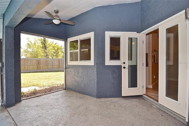 entrance to property featuring ceiling fan and a patio area