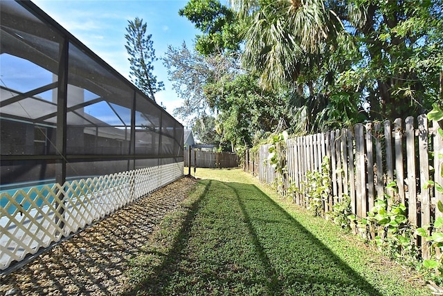 view of yard with glass enclosure