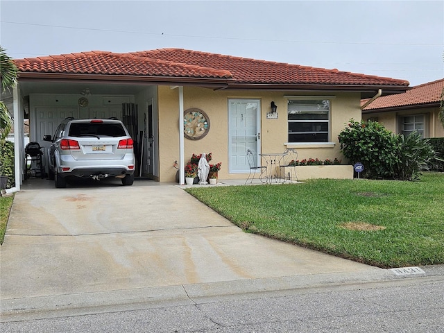 mediterranean / spanish-style home with a front yard and a carport