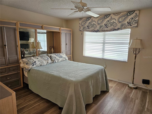 bedroom with ceiling fan, a textured ceiling, and hardwood / wood-style flooring