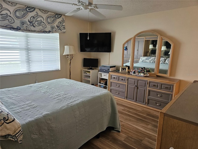 bedroom featuring a textured ceiling, dark hardwood / wood-style floors, and ceiling fan