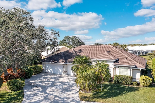 view of front of home with a garage and a front lawn