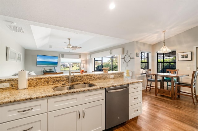 kitchen with stainless steel dishwasher, ceiling fan, white cabinetry, and sink