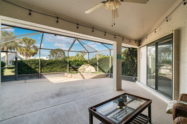 unfurnished sunroom with ceiling fan