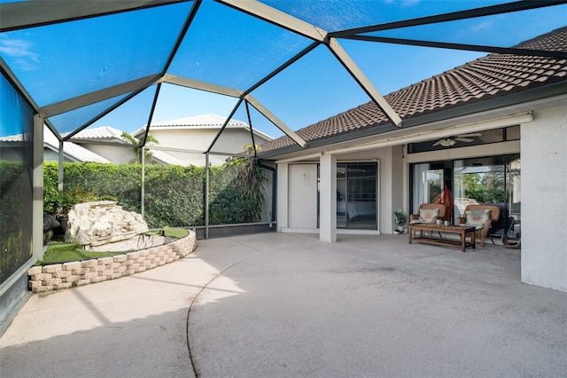 view of patio / terrace with glass enclosure and ceiling fan