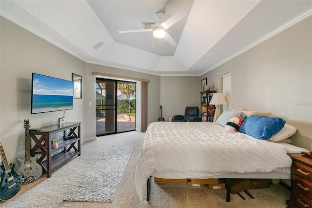 bedroom featuring ceiling fan, access to exterior, a textured ceiling, a tray ceiling, and carpet floors