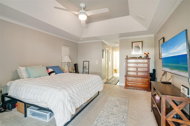 bedroom featuring a tray ceiling, ceiling fan, light colored carpet, and ornamental molding