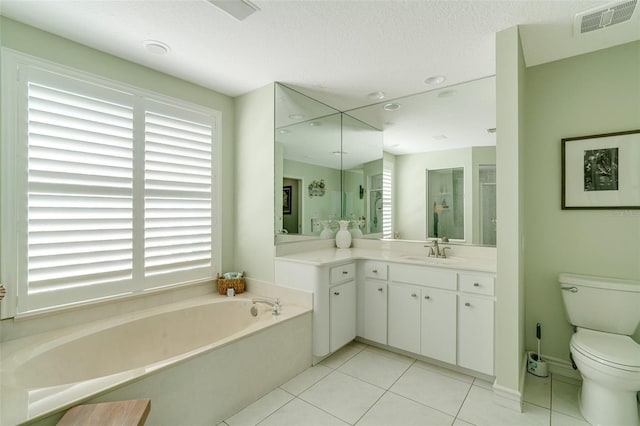 bathroom with a bath, tile patterned floors, vanity, and toilet