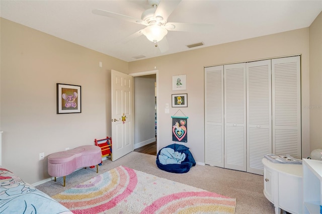 carpeted bedroom with a closet and ceiling fan