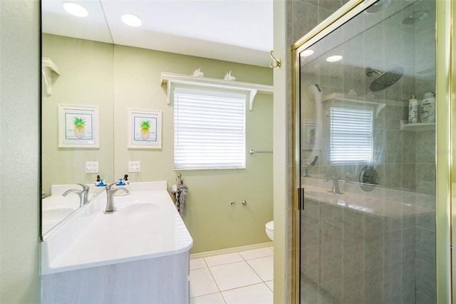 bathroom featuring tile patterned floors, toilet, an enclosed shower, and vanity